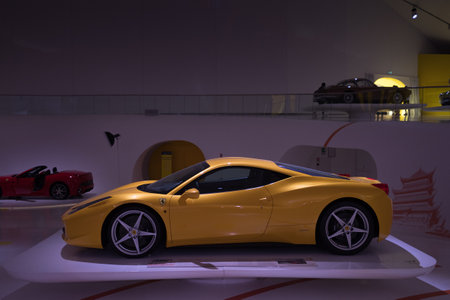 Modena, Italy - July 14, 2021: Yellow racing Ferrari 458 model high-performance Italian sports car in a dark hangar in Museo Casa Enzo Ferrari, Italy.のeditorial素材