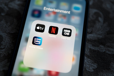 Krakow, Poland - July 14, 2021: Netflix application icon among Apple TV+, Amazon Prime Video, and HBO GO in Entertainment Folder on Apple iPhone 12 Pro MAX screen close-up. Popular streaming services.のeditorial素材