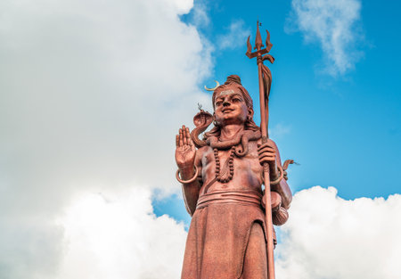 Huge Shiva statue Mangal Mahadev is a 33 m art piece in Ganga talao temple on the blue cloudy sky, Mauritius island.の写真素材