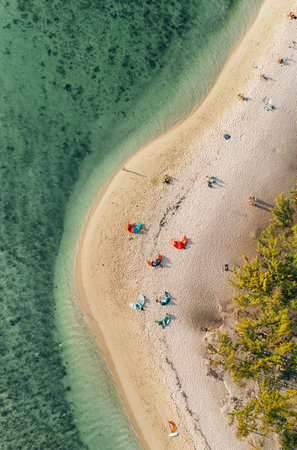 Colorful kites on Le Morne sandy beach with a turquoise clean lagoon with coral reefs on Mauritius island - wonderful kiteboarding and windsurfing spot. Exotic traveling and active people concept.の写真素材