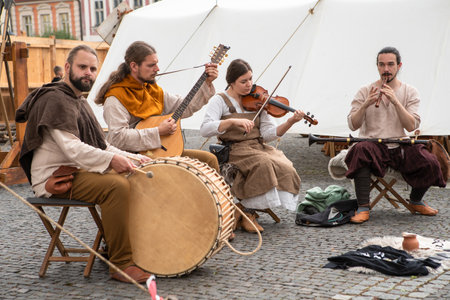 Zilina, Slovak RepubliÑ, Slovakia - July 28, 2023: Four participants street band playing folk music during traditional annual medieval restoration known as a "Stredoveky den" in Zilina, Slovakia.のeditorial素材