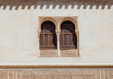Marble capitals and stucco decoration on two windows in Patio del Cuarto Dorado in Mexuar in Comares Palace Alhambra, Andalusia, Spain. Magic breathtaking carved decoration in orient style.のeditorial素材