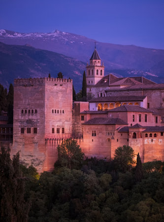 Alhambra is a medieval palace and fortress complex with Sierra Nevada snowy mountains in Granada, Andalusia, Spain. Known as Capital of Nasrid Kingdom or Emirate of Granada. Beautyful sunset hour timeのeditorial素材