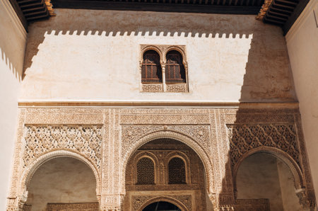 Marble capitals and stucco decoration of the portico in Patio del Cuarto Dorado in Mexuar in Comares Palace Alhambra, Andalusia, Spain. Magic breathtaking carved decoration  in orient style.のeditorial素材
