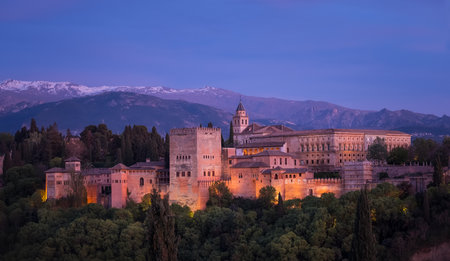 Alhambra is a medieval palace and fortress complex with Sierra Nevada snowy mountains in Granada, Andalusia, Spain. Known as Capital of Nasrid Kingdom or Emirate of Granada. Panoramic sunset hour timeのeditorial素材