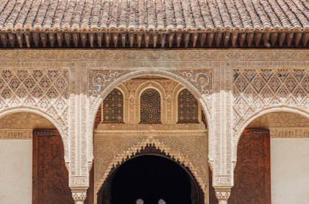 Marble capitals and stucco decoration of the portico in Court of Myrtles in Comares Palace Alhambra, Andalusia, Spain. Magic breathtaking carved decoration in Orient style.のeditorial素材