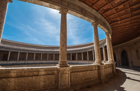 Incredible wide-angle view of galleries with columns in the inner circular patio in Palace of Charles V in Alhambra complex in Granada, Andalusia, Spain.のeditorial素材