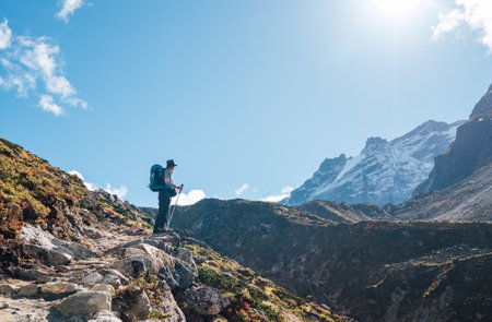 Young hiker backpacker man enjoying valley view in Makalu Barun Park route near Khare during high altitude acclimatization walk. Mera peak trekking route, Nepal. Active vacation concept imageの写真素材