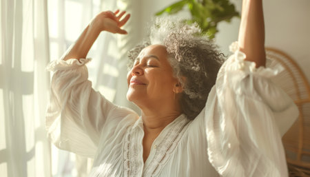 This image features a woman basking in sunlight with eyes closed and arms raised, exuding a sense of bliss and serenity in a bright, airy room surrounded by green plants. Mental heの素材