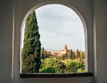 Church of St Maria in Alhambra palace Generalife Gardens view from ancient arch window. Alhambra castle, Andalusia, Spain.の写真素材