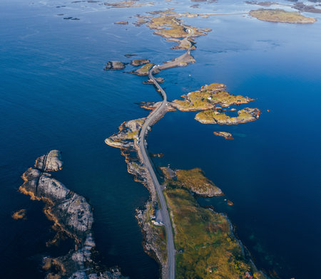 Atlantic Ocean Road with a famous Storseisundet Bridge top view. Picturesque northern Norway nature landscape and modern highway construction masterpiece union aerial photo. Atlanterhavsvegen, Norway.の写真素材