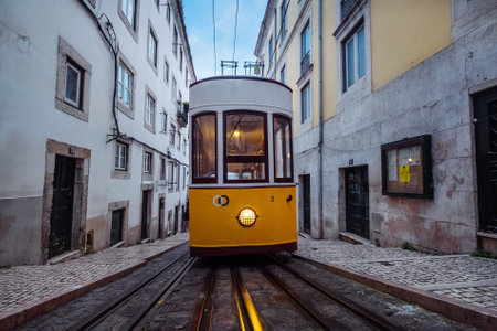 Wide angle view of Bica Funicular as it travels between Rua da Bica de Duarte Belo and Rua de Sao Paulo. Retro masterpiece in old Lisboa town, Portugal.の写真素材
