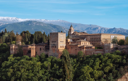 Charles V Palace and Church of Santa Maria de la Alhambra in medieval fortress complex with Sierra Nevada snowy mountains, Andalusia, Spain. Known as a Capital of Nasrid Kingdom or Emirate of Granada.の写真素材