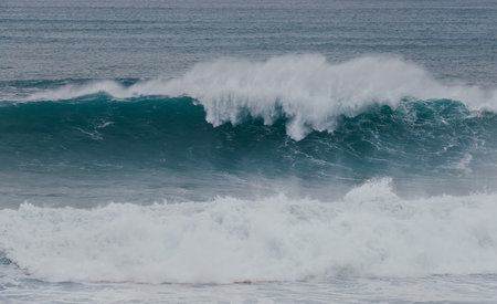 Huge Atlantic ocean wave during international surfers challenge at Praia do Norte in Nazare, Farol...
