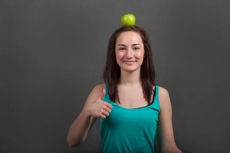 beautiful woman with green appleの写真素材