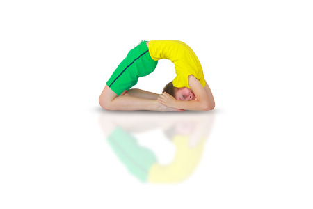little boy doing yoga on white backgroundの写真素材