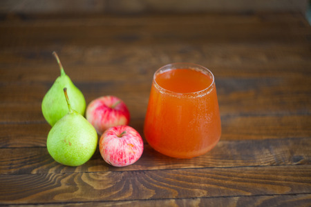 juice of pears and apples  in glass on wooden tableの写真素材