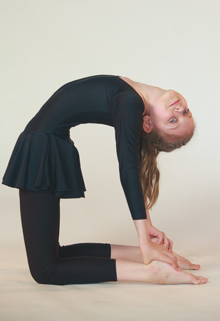 little girl doing yoga on white background