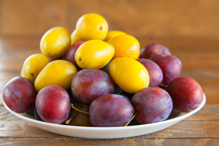 appetizing ripe plum on tableの写真素材