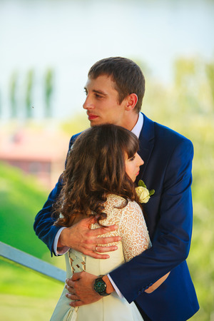 Happy beautiful bride standing on the street and smilingの写真素材