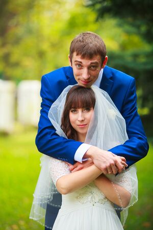 Happy beautiful bride standing on the street and smilingの写真素材