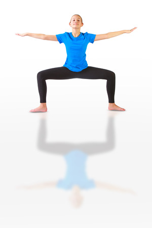 beautiful flexible woman doing yoguna white backgroundの写真素材