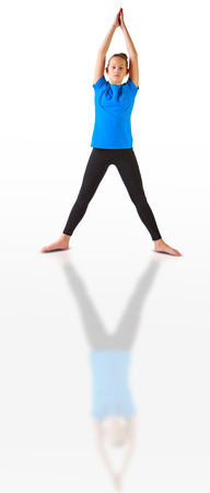 beautiful flexible woman doing yoguna white backgroundの写真素材