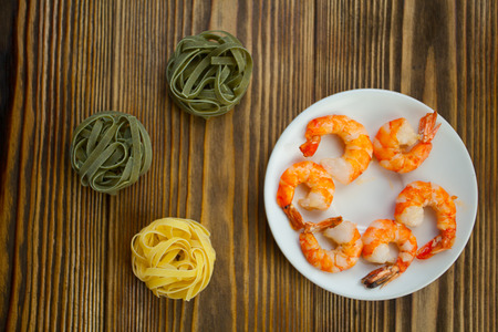 delicious prawns on a plate on a wooden background in rustic styleの写真素材