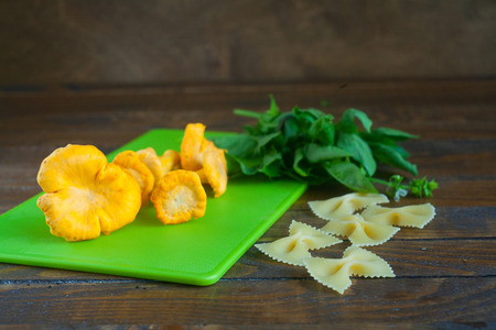 Delicious wild mushrooms chanterelle on the tableの写真素材