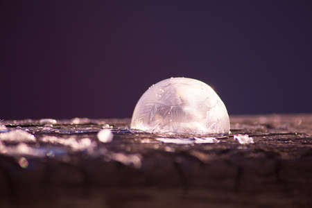 Beautiful abstract winter background with frozen soap bubble