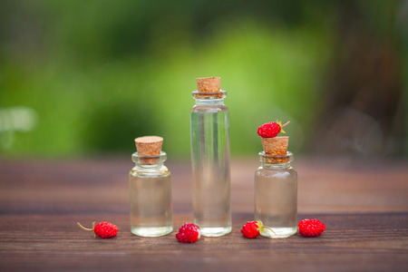 Essence of Wild strawberry on a table in a beautiful glass bottleの写真素材
