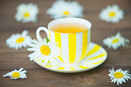 porcelain cup with green tea on a tableの写真素材