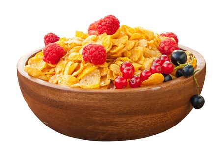 Breakfast of cornflakes with berries in a wooden bowl