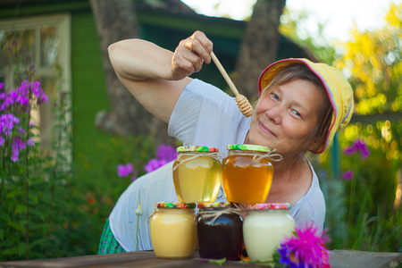 Delicious delicious honey in a jar on the tableの写真素材