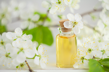 Essence of flowers on a table in a beautiful glass jarの写真素材