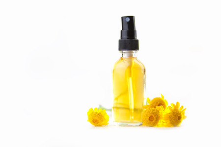 Essence of flowers on table in beautiful glass Bottleの写真素材