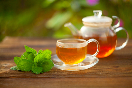 delicious green tea in a beautiful glass bowl on a tableの写真素材