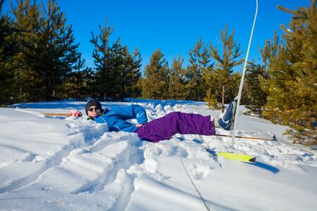 handsome man with skis in the winter forestの写真素材