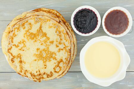 Plate with pancakes on the table top view
