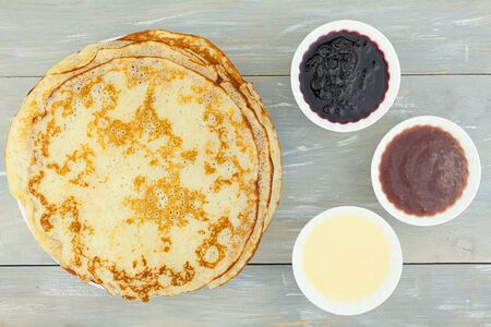 Plate with pancakes on the table top view