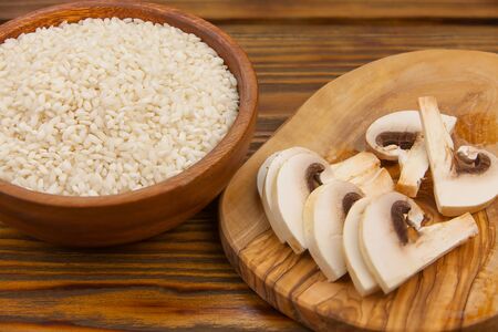 Tasty appetizing risotto on a white plate on a wooden tableの写真素材