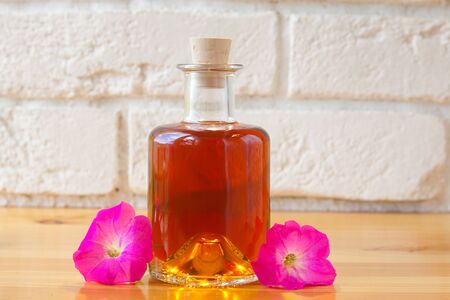 petunia essential oil in a beautiful bottle on the tableの写真素材