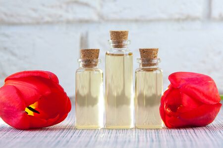 Essence of flowers on a table in a beautiful glass jarの写真素材