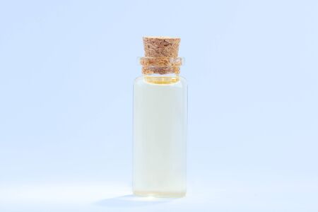 Essence of flowers on a table in a beautiful glass Bottleの写真素材