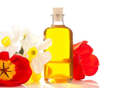 Essence of flowers on a table in a beautiful glass jarの写真素材