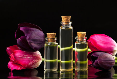 Essence of flowers on a table in a beautiful glass jarの写真素材