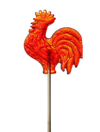 colored candy on a stick in the form of a cockerel heart and flowersの写真素材