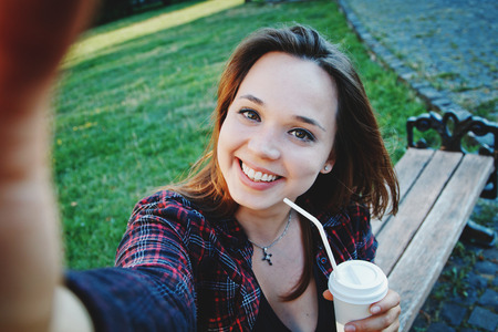 beautiful girl student sitting on bench near universityの写真素材