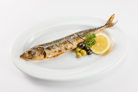 juicy piece of fish with tomato and olivesの写真素材