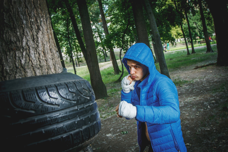 strong young boxer trains fists and handsの写真素材